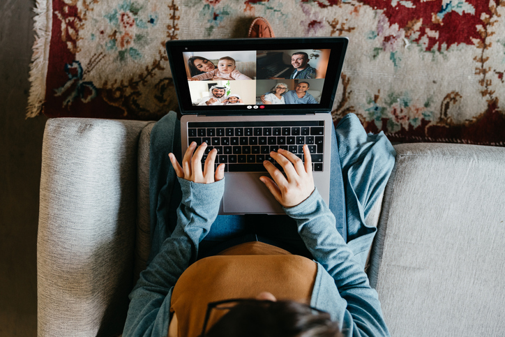 Young woman using a laptop to connect with her friends and parents during quarantine